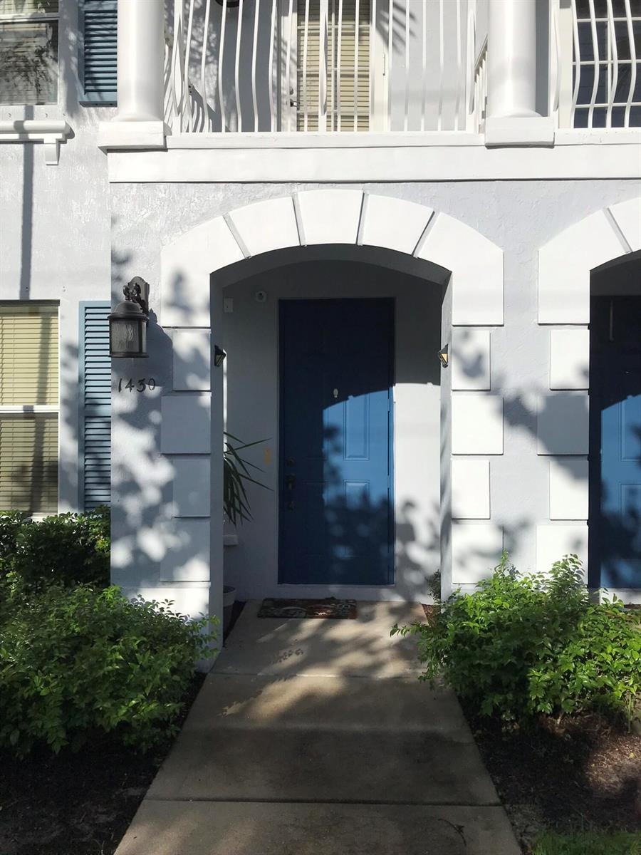 A blue front door is framed by a white arched entryway on a light-colored building — 1430 Via Alferi, Boynton Beach FL 33426, BOYNTON BEACH, FL