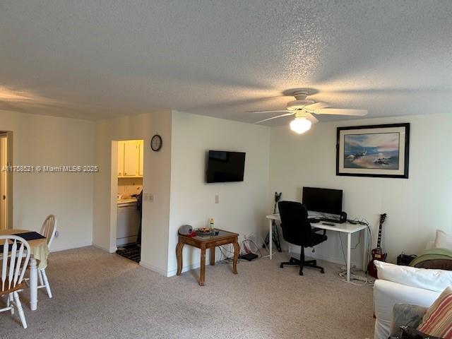 A living room features a ceiling fan, a wall-mounted television, a desk, and a dining area — 1011 Ellesmere A # 1011, Deerfield Beach FL 33442, DEERFIELD BEACH, FL