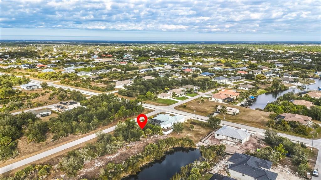 An aerial view shows a residential neighborhood with a red location pin over a vacant lot — 9484 NASTRAND CIRCLE, PORT CHARLOTTE, FL