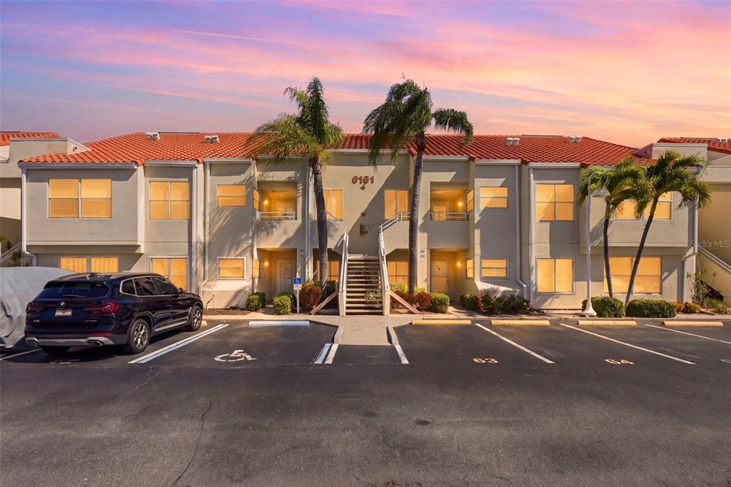 A two-story apartment building with a red tile roof and a parking lot in front — 6151 BAHIA DEL MAR BOULEVARD UNIT 123, ST PETERSBURG, FL