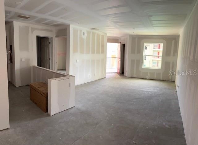 An unfinished interior room features drywall walls, a concrete floor, and a sliding glass door — 3024 PARKWAY BOULEVARD UNIT 204, KISSIMMEE, FL