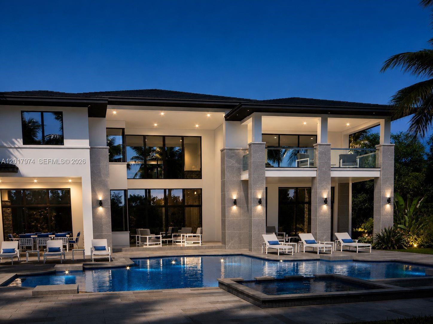 A two-story modern house with a swimming pool and patio at dusk — 11250 NW 4th St, Plantation FL 33325, PLANTATION, FL