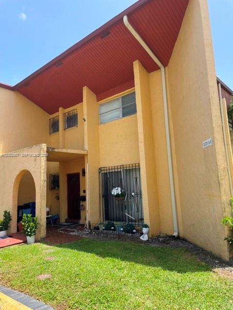 A two-story yellow stucco building features a red roof overhang and a ground-level entrance — 13721 SW 84th St # G, Miami FL 33183, MIAMI, FL