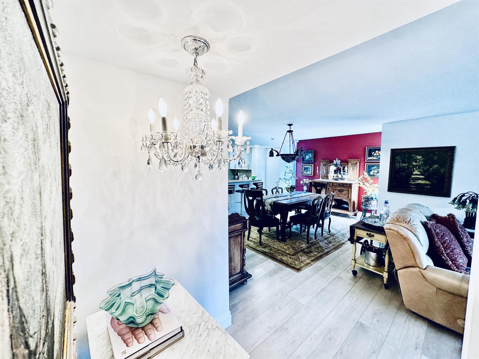 A view from a foyer into a dining room with a chandelier and red wall — 6662 Boca Del Mar Drive # 111, Boca Raton FL 33433, BOCA RATON, FL