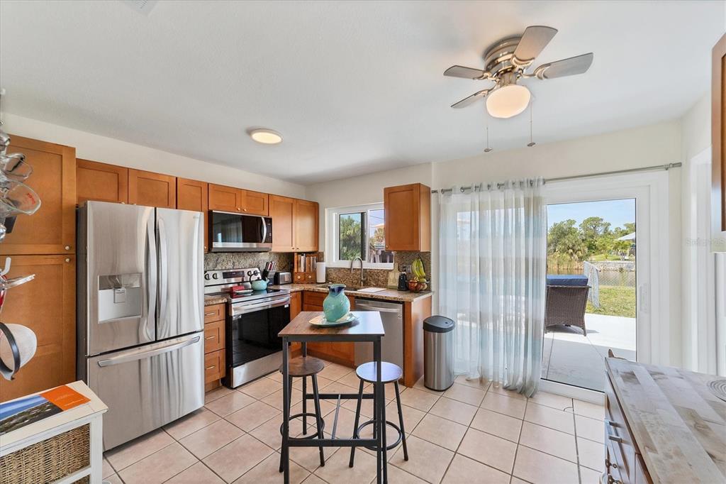 An aerial view of a single-story house with a backyard, dock, and canal — 9150 ARRID CIRCLE, PORT CHARLOTTE, FL