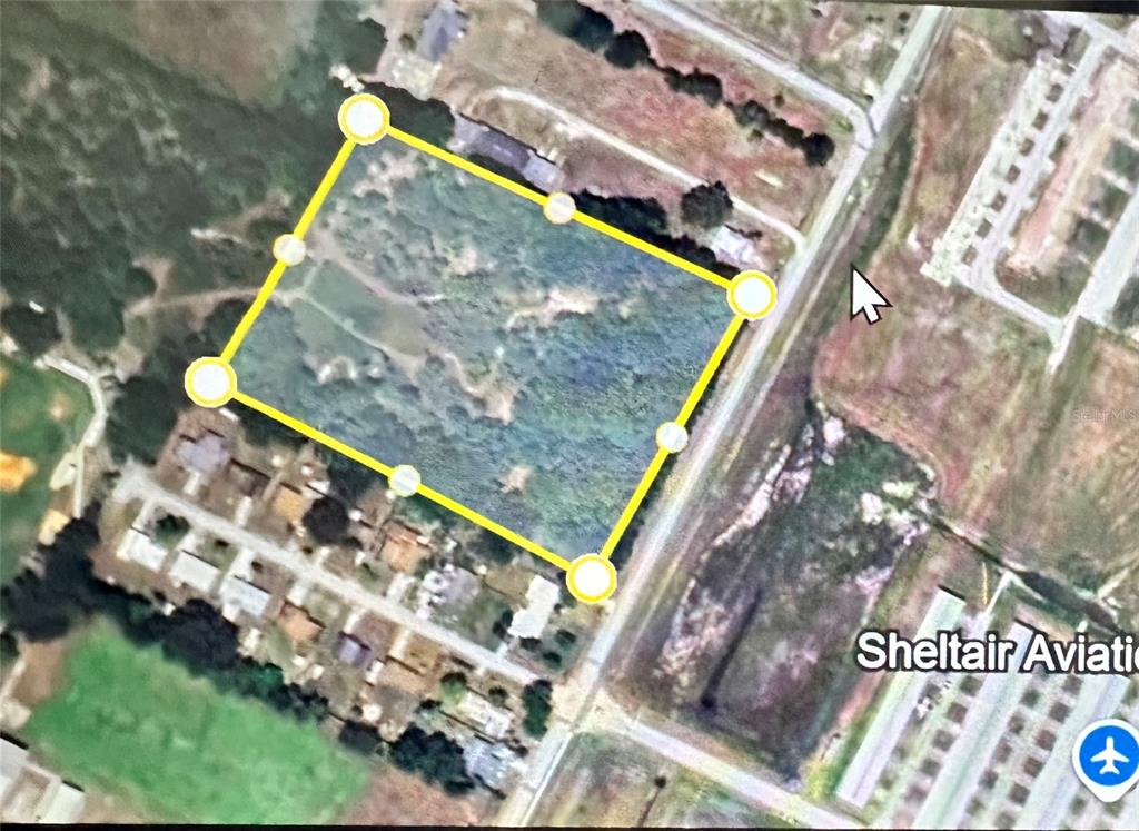 An aerial map view shows a rectangular plot of land outlined in yellow — PATRICK STREET, KISSIMMEE, FL