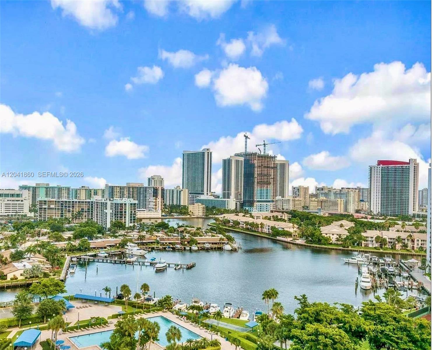 An elevated view of a marina, waterfront residential buildings, and a city skyline — 500 Three Islands Blvd # 223, Hallandale Beach FL 33009, HALLANDALE BEACH, FL
