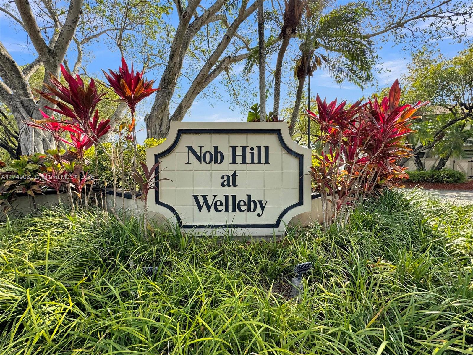 A sign for Nob Hill at Welleby stands surrounded by tropical plants and trees — 9745 NW 37th St # 9745, Sunrise FL 33351, SUNRISE, FL