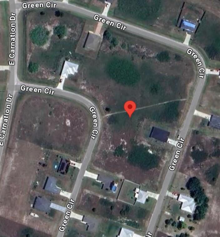 This is a satellite map view of a vacant residential lot on a curved street — 9050 Green Circle, FL 33935, FL