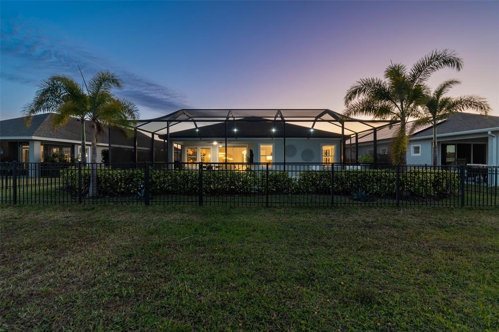 The exterior of a house with a screened-in pool enclosure and two palm trees — 5424 SILVER SUN DRIVE, APOLLO BEACH, FL
