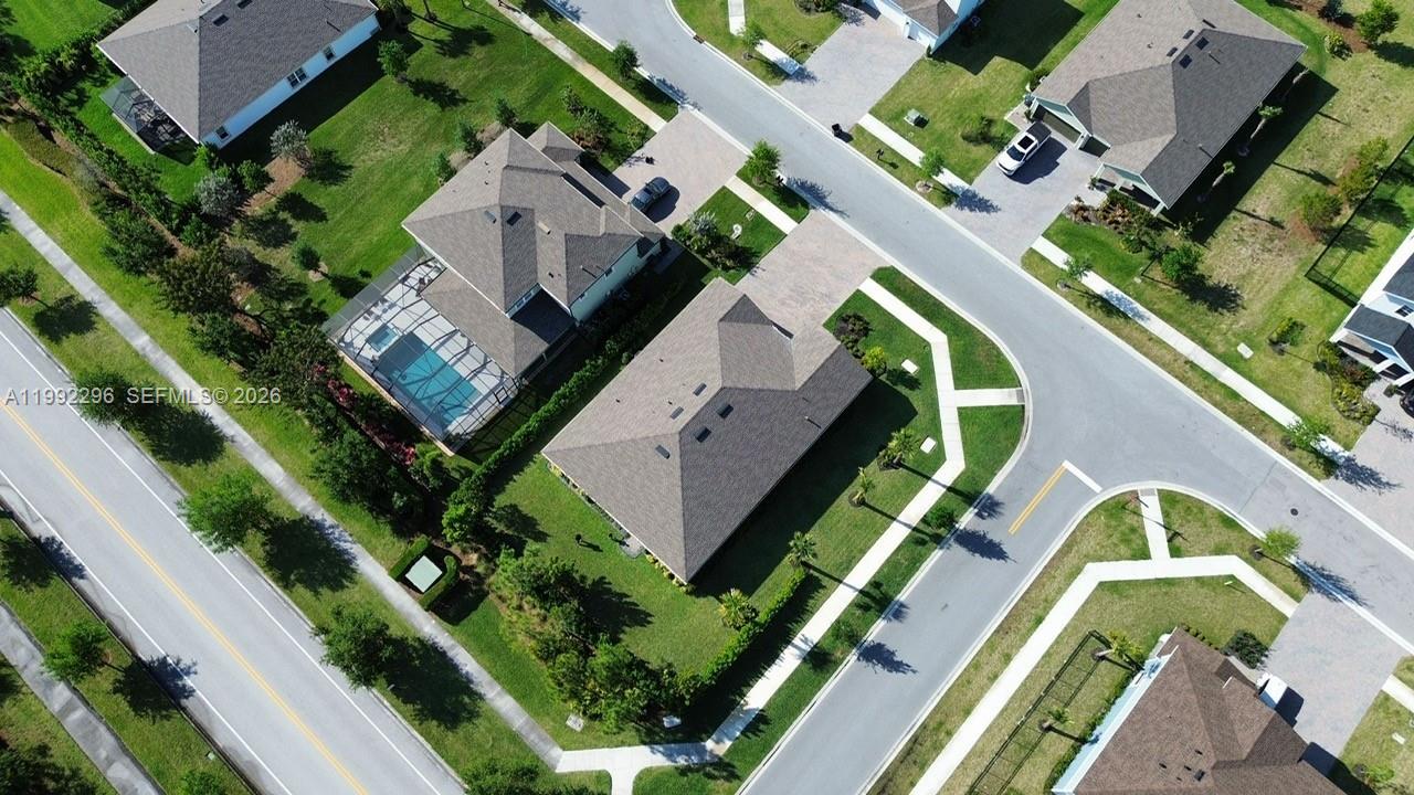 An aerial view shows several suburban houses with driveways, lawns, and a swimming pool — 19148 N Broad Shore Walk, Loxahatchee FL 33470, LOXAHATCHEE, FL