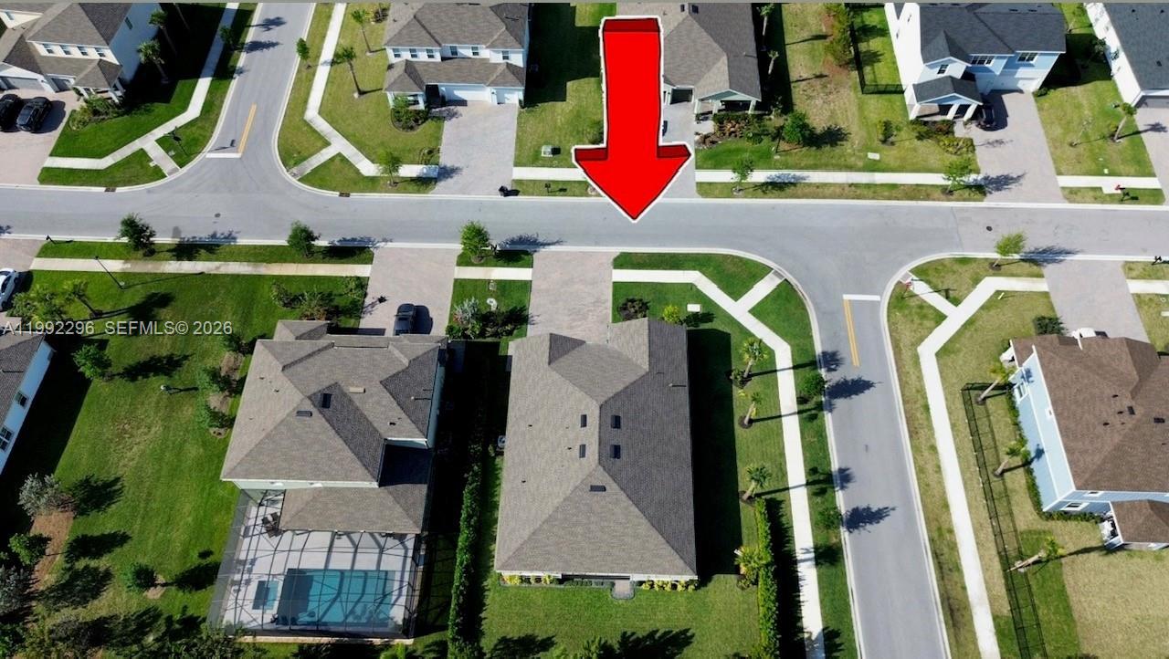 An aerial view shows a suburban neighborhood with houses, driveways, and a red arrow — 19148 N Broad Shore Walk, Loxahatchee FL 33470, LOXAHATCHEE, FL