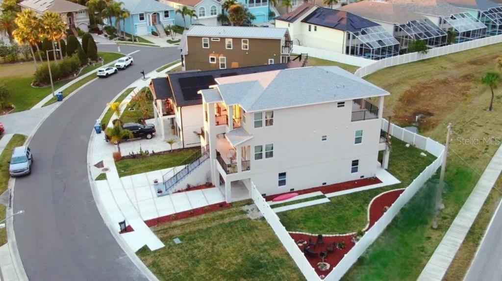 An aerial view shows a three-story house with a balcony and a fenced backyard — 5324 JOBETH DRIVE, NEW PORT RICHEY, FL