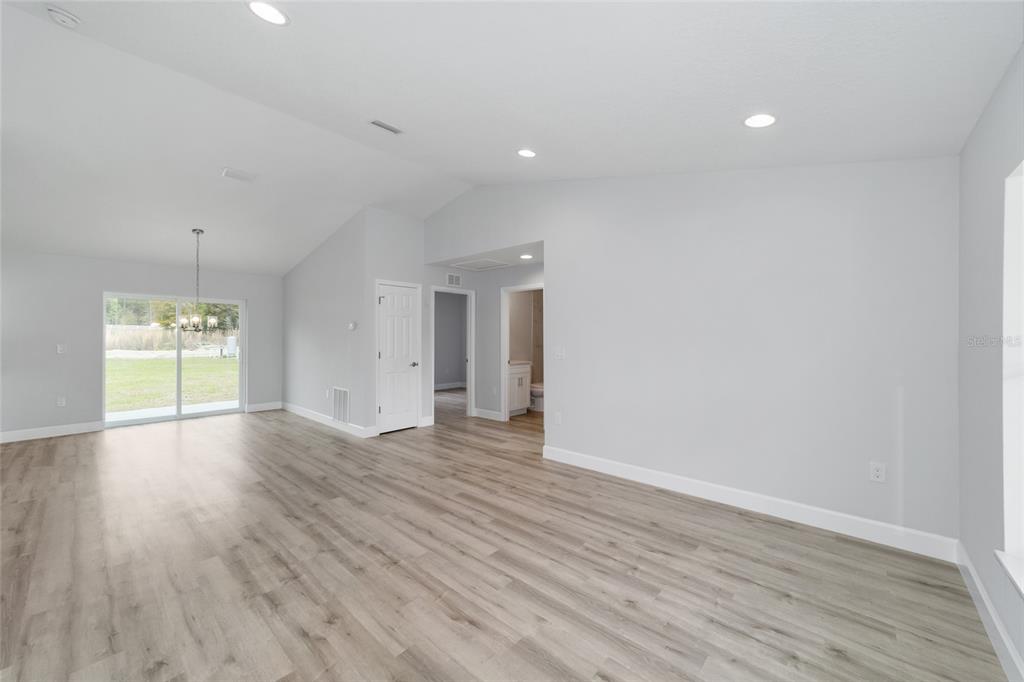 A single-story gray house with a white front door and a one-car garage — 15342 SW 38TH PLACE, OCALA, FL