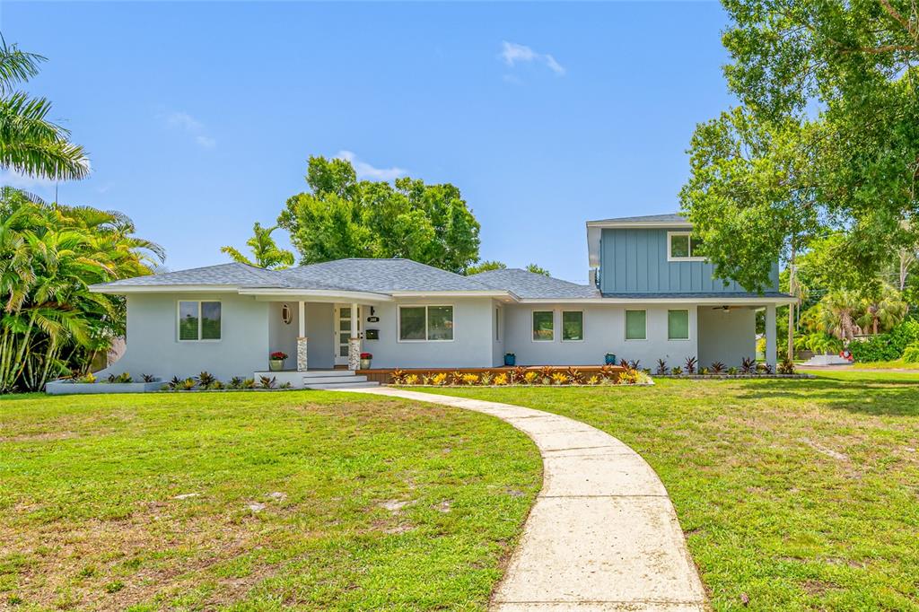 A light gray, single-story house with a two-story section and a curved concrete walkway — 380 VILLAGRANDE AVENUE S, ST PETERSBURG, FL