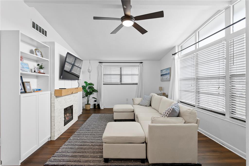 An entryway features a white front door, a gray console table, and a wall mirror — 2407 S LOIS AVENUE, TAMPA, FL