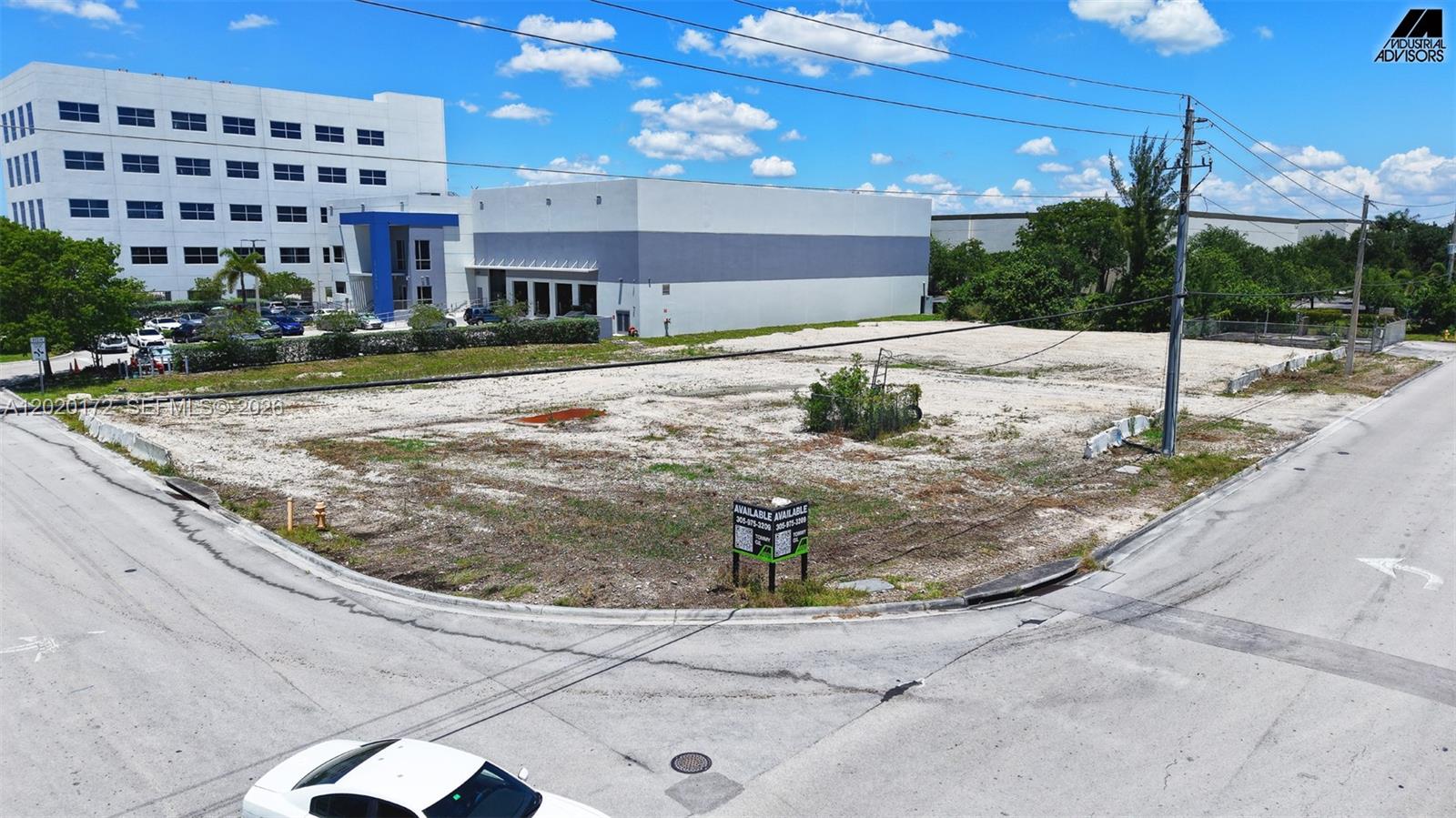 An aerial view shows a vacant, cleared corner lot with a real estate sign — 11501 NW 124th St, Medley FL 33178, MEDLEY, FL