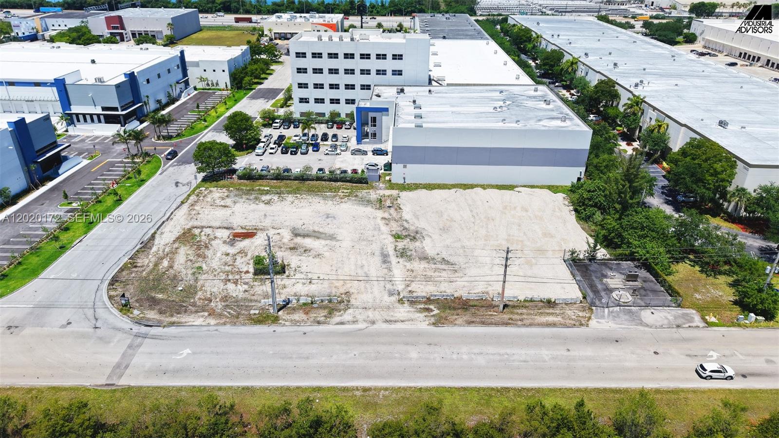 An aerial view shows a vacant, cleared rectangular lot adjacent to a large industrial building — 11501 NW 124th St, Medley FL 33178, MEDLEY, FL