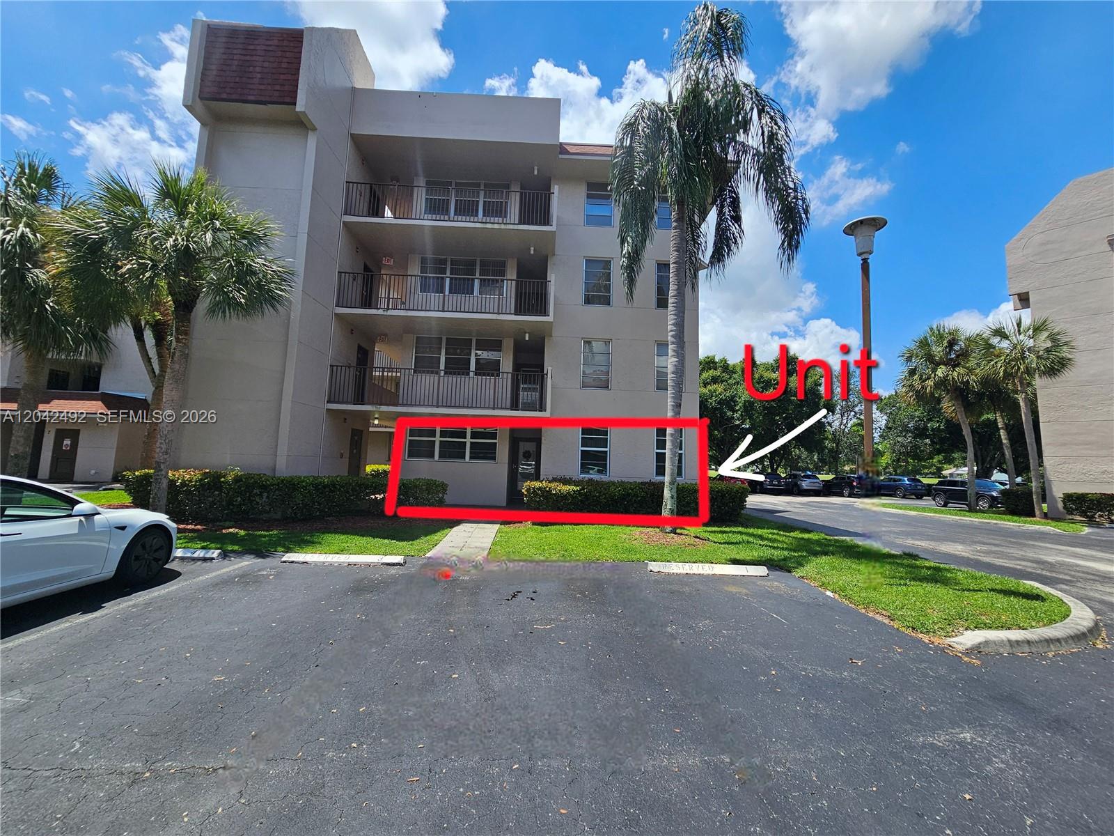 A ground-floor apartment unit is highlighted in red on the exterior of a multi-story building — 9520 Seagrape Dr # 106, Davie FL 33324, DAVIE, FL
