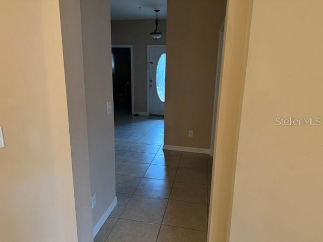 A view through a doorway shows a tiled hallway leading to a front door — 472 HARBOR WINDS COURT, WINTER SPRINGS, FL