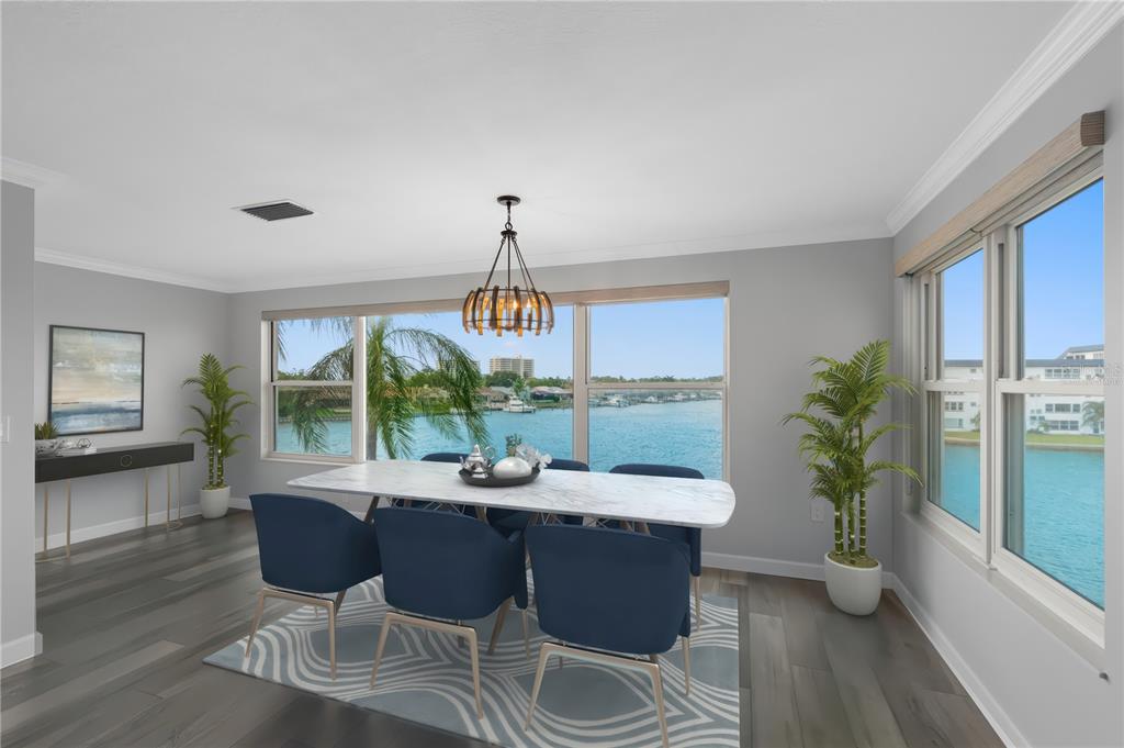 A dining room with a marble table, blue chairs, and a waterfront view — 6075 SHORE BOULEVARD S UNIT 315, GULFPORT, FL