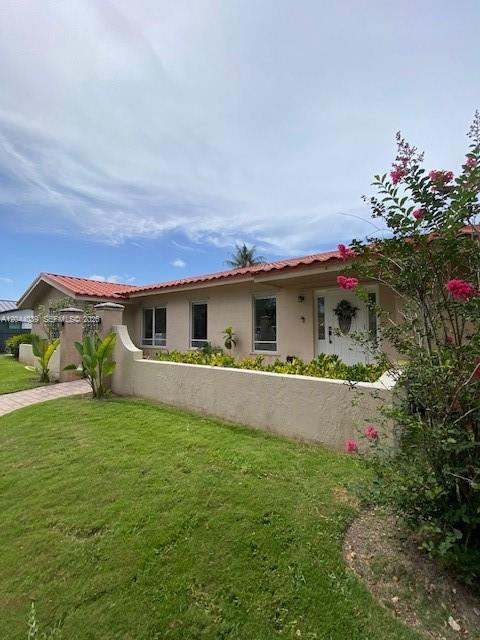 A single-story house with a red tile roof and a low stucco wall in front — 9760 SW 128th St, Miami FL 33176, MIAMI, FL