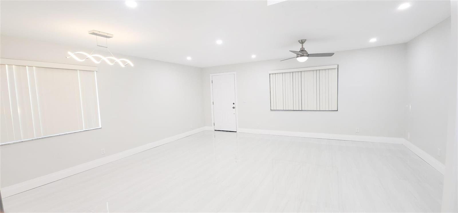 An empty room with white walls, light-colored tile flooring, a ceiling fan, and modern lighting — 343 Normandy H # 343, Delray Beach FL 33484, DELRAY BEACH, FL