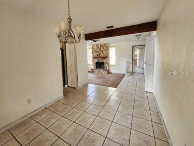 A dining area with a chandelier and tile floors leads to a living room with carpet — 270 AMBERWOOD COURT, ORMOND BEACH, FL