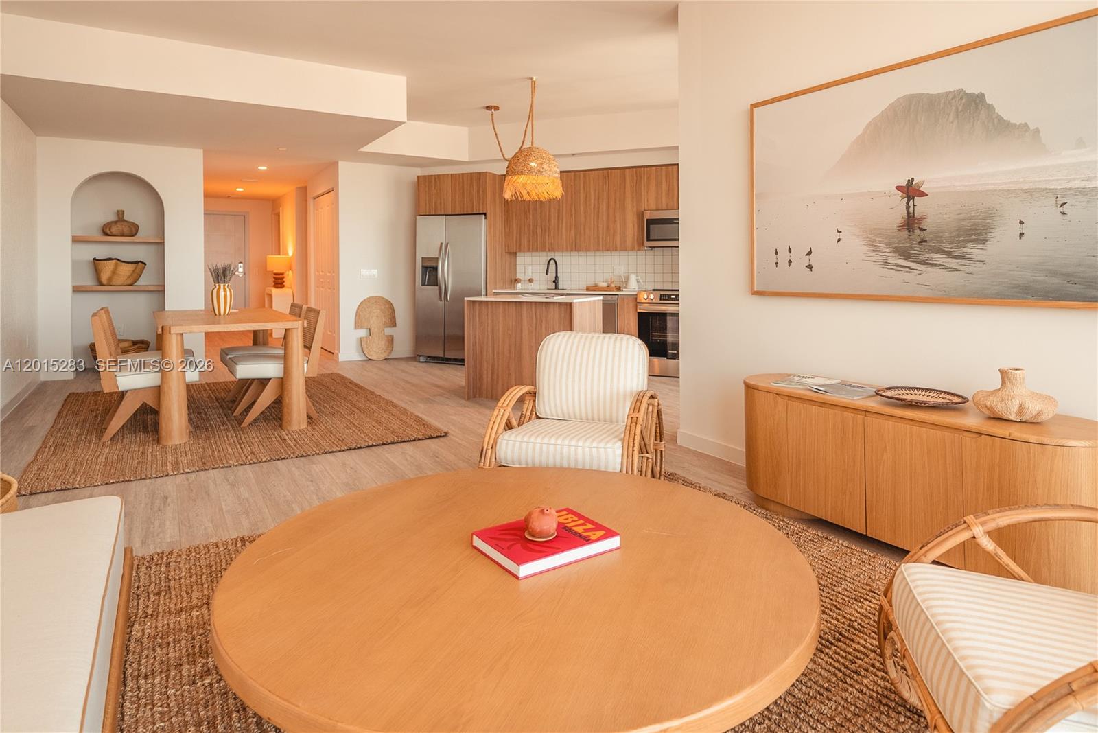 A modern open-concept living and dining area features light wood cabinetry and neutral furniture — 275 SW 6th St # 5308, Miami FL 33130, MIAMI, FL
