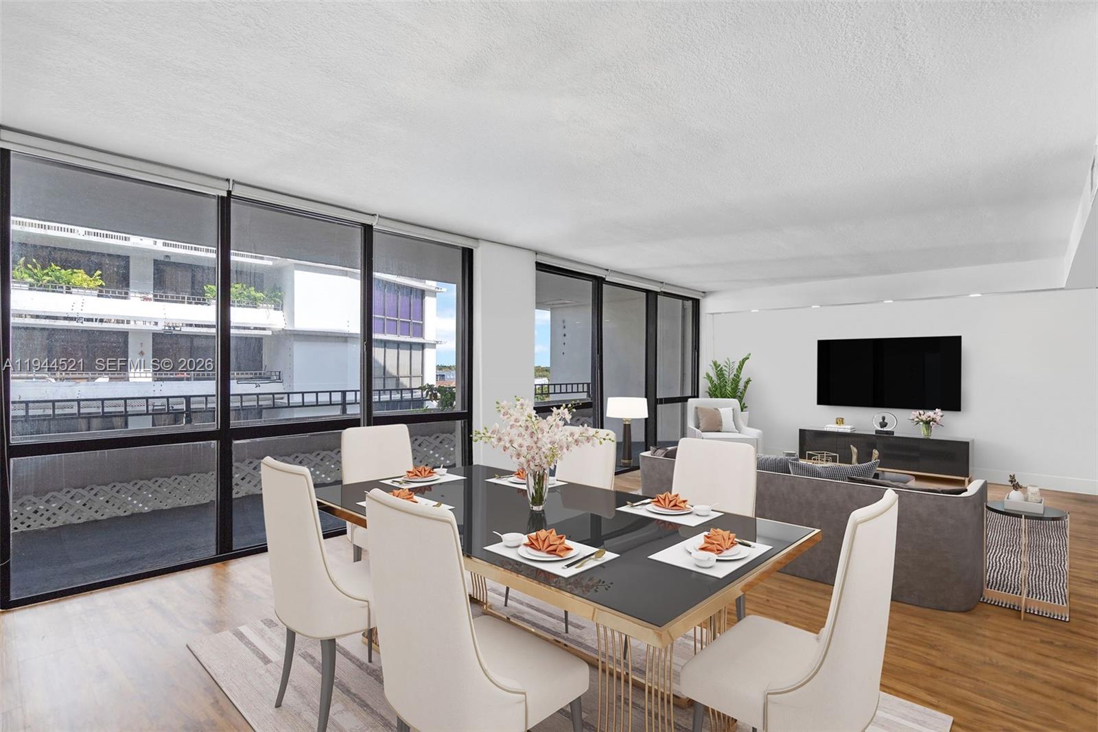 A dining area with a glass-topped table and chairs opens into a living room — 13953 Kendale Lakes Cir # 608B, Miami FL 33183, MIAMI, FL