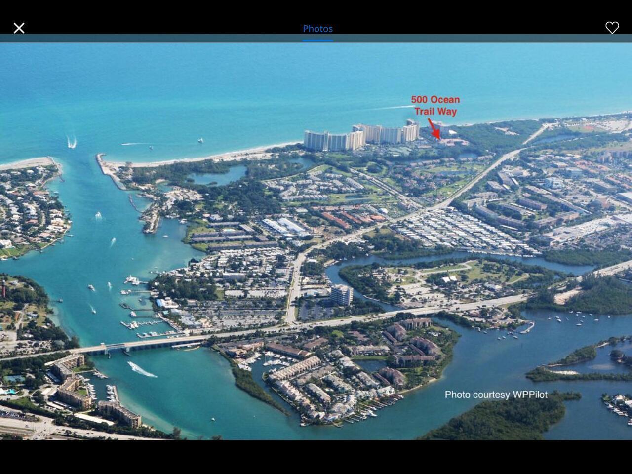 This aerial view shows a coastal residential area with a bridge, waterways, and oceanfront buildings — 500 Ocean Trail Way # 406, Jupiter FL 33477, JUPITER, FL