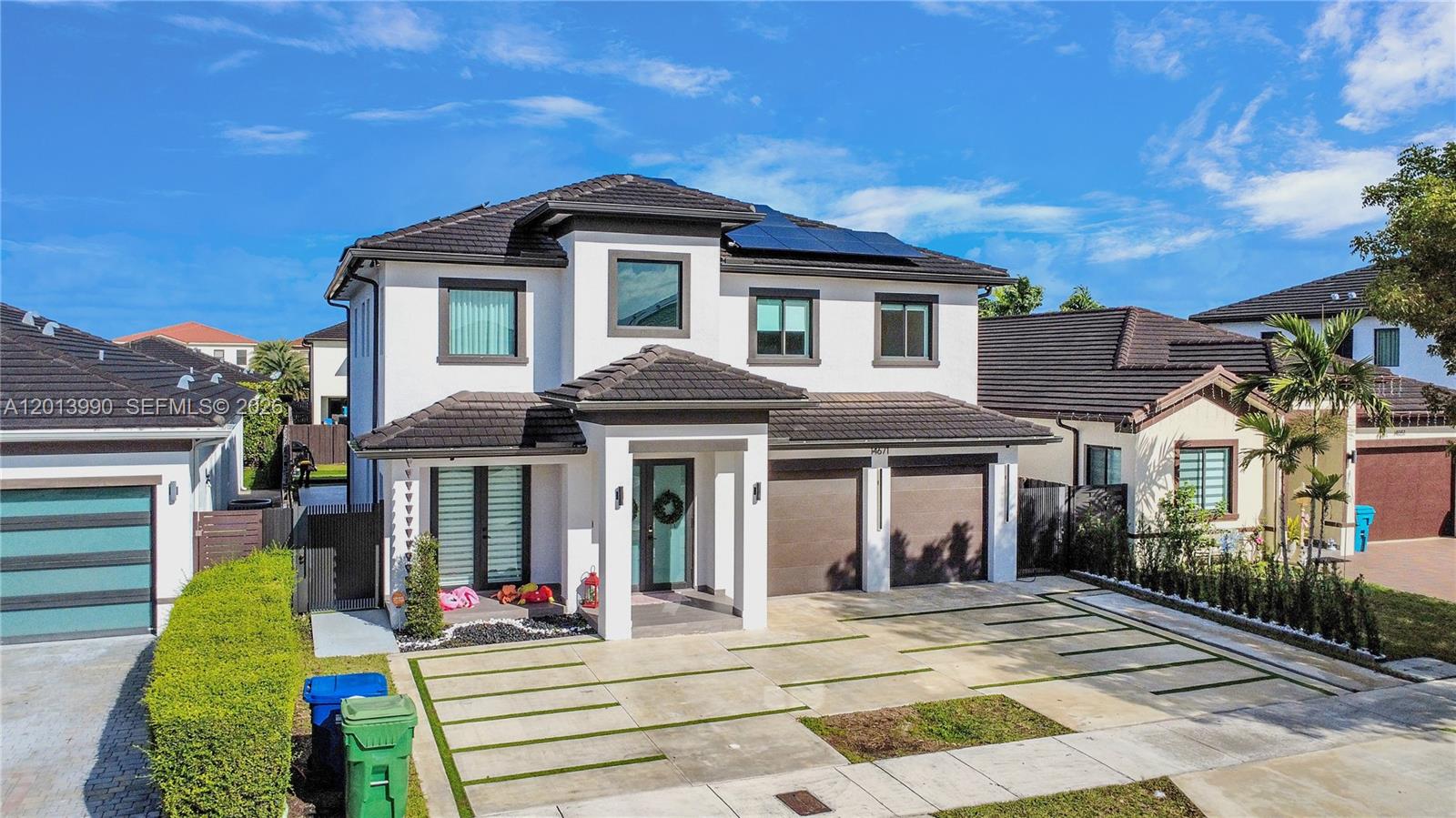 A two-story white house with a dark tiled roof, solar panels, and a paved driveway — 14671 SW 20th St, Miami FL 33175, MIAMI, FL