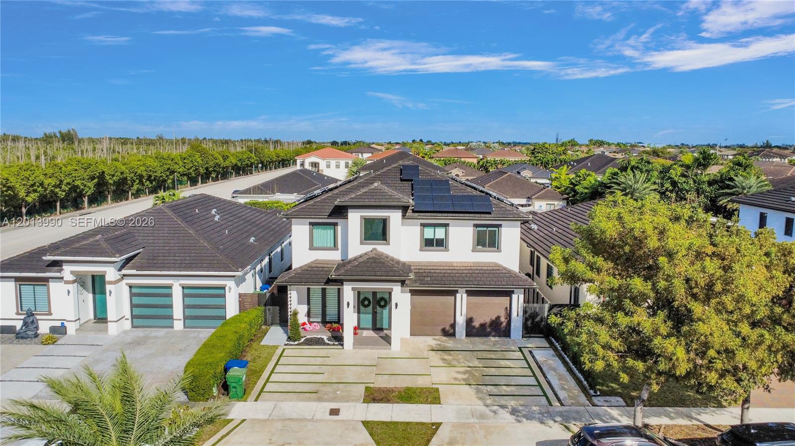 An aerial view shows a two-story house with a tiled roof, solar panels, and driveway — 14671 SW 20th St, Miami FL 33175, MIAMI, FL