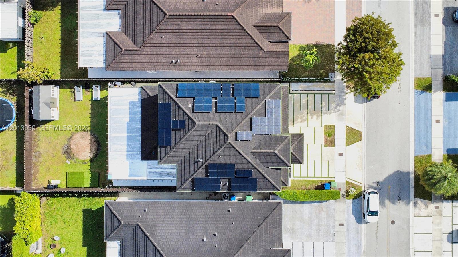 An aerial view shows a house with solar panels on the roof and a driveway — 14671 SW 20th St, Miami FL 33175, MIAMI, FL
