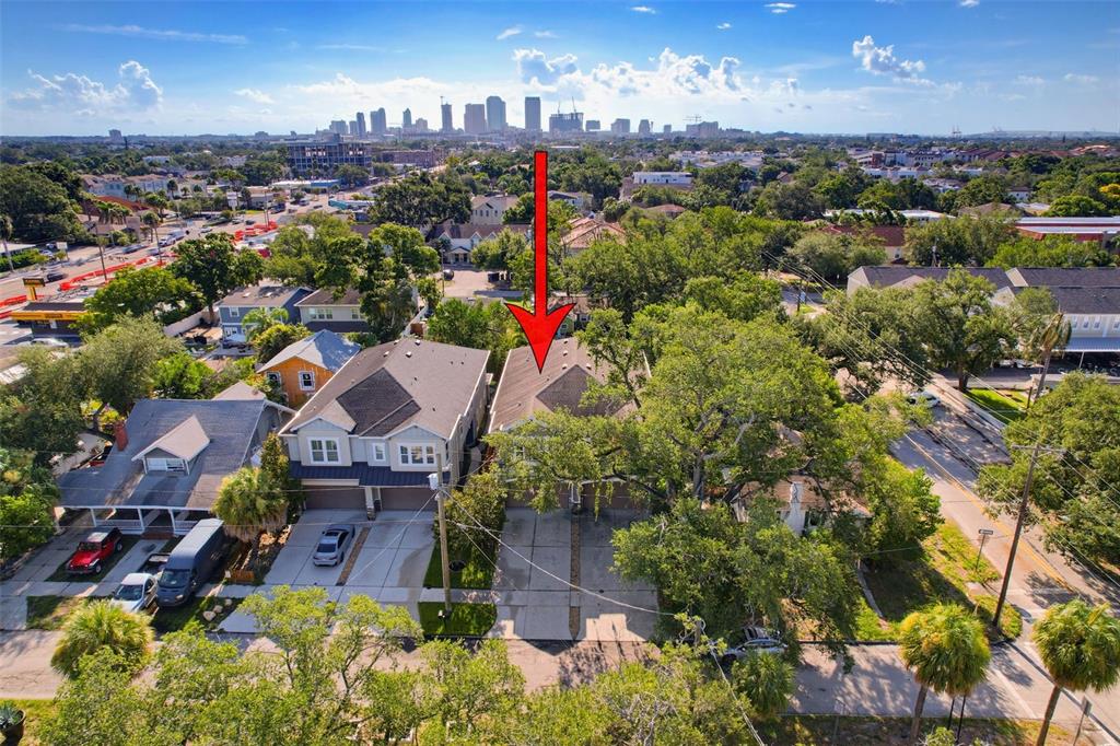 An aerial view shows a residential street with houses and a distant city skyline — 112 S BUNGALOW PARK AVENUE UNIT 1, TAMPA, FL