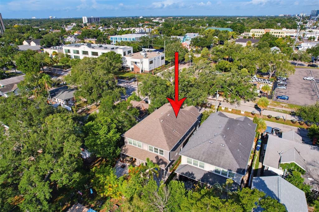 An aerial view shows a two-story house with a brown roof and a red arrow — 112 S BUNGALOW PARK AVENUE UNIT 1, TAMPA, FL
