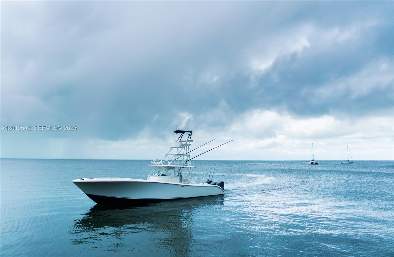A white center console fishing boat floats on calm water under a cloudy sky — 8 Ocean View Blvd, Key Largo FL 33037, KEY LARGO, FL