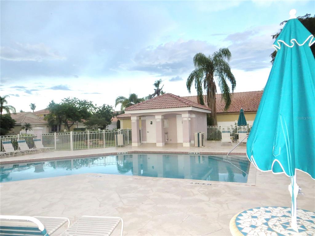 A swimming pool with a tiled deck and a small covered pavilion under a palm tree — 510 SW 181ST WAY, PEMBROKE PINES, FL