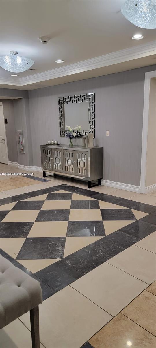 A foyer features a checkered tile floor, a mirrored console table, and a wall mirror — HOLLYWOOD, FL