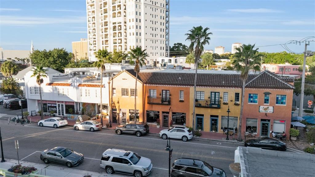 An elevated view of a street with parked cars and a row of colorful commercial buildings — 530 S ORANGE AVENUE, SARASOTA, FL