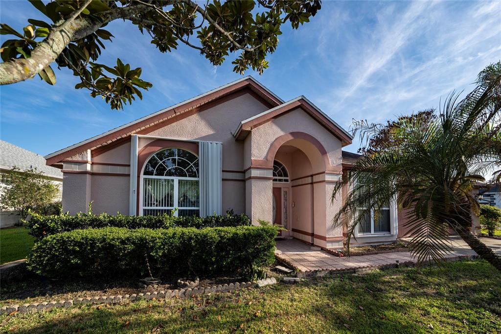 A single-story house with a stucco exterior, arched entryway, and a large front window — 2836 SPIVEY LANE, ORLANDO, FL