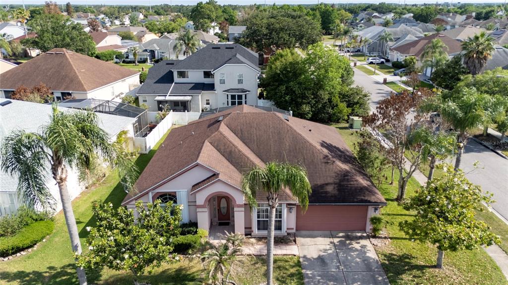 An aerial view shows a single-story house with a brown roof and a driveway — 2836 SPIVEY LANE, ORLANDO, FL