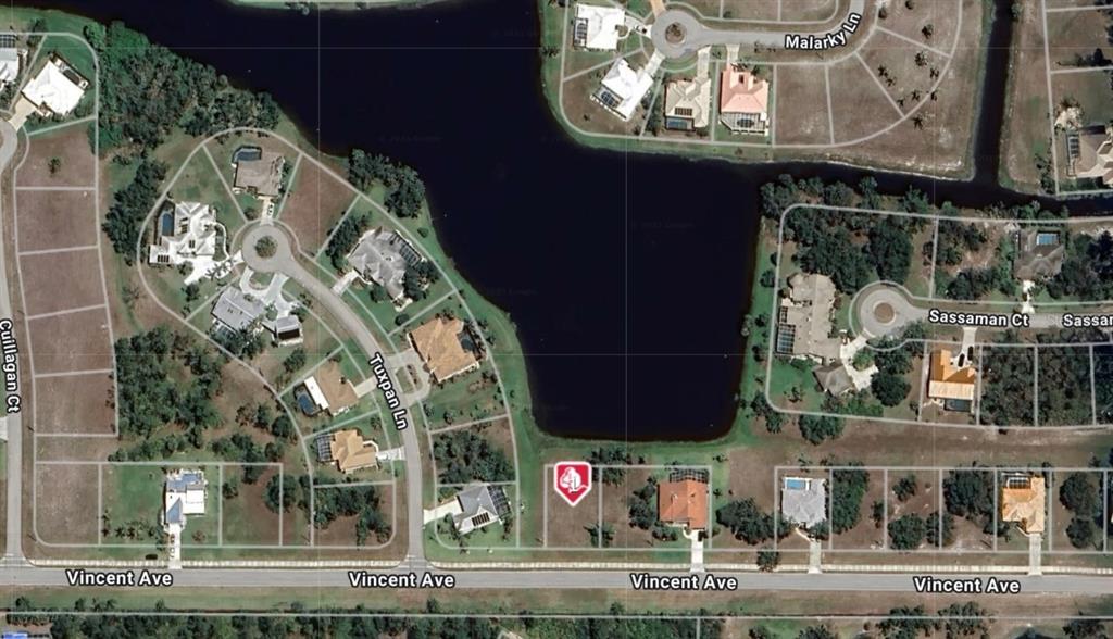 This is an aerial map view of a residential neighborhood featuring a lake and lots — 24188 VINCENT AVENUE, PUNTA GORDA, FL