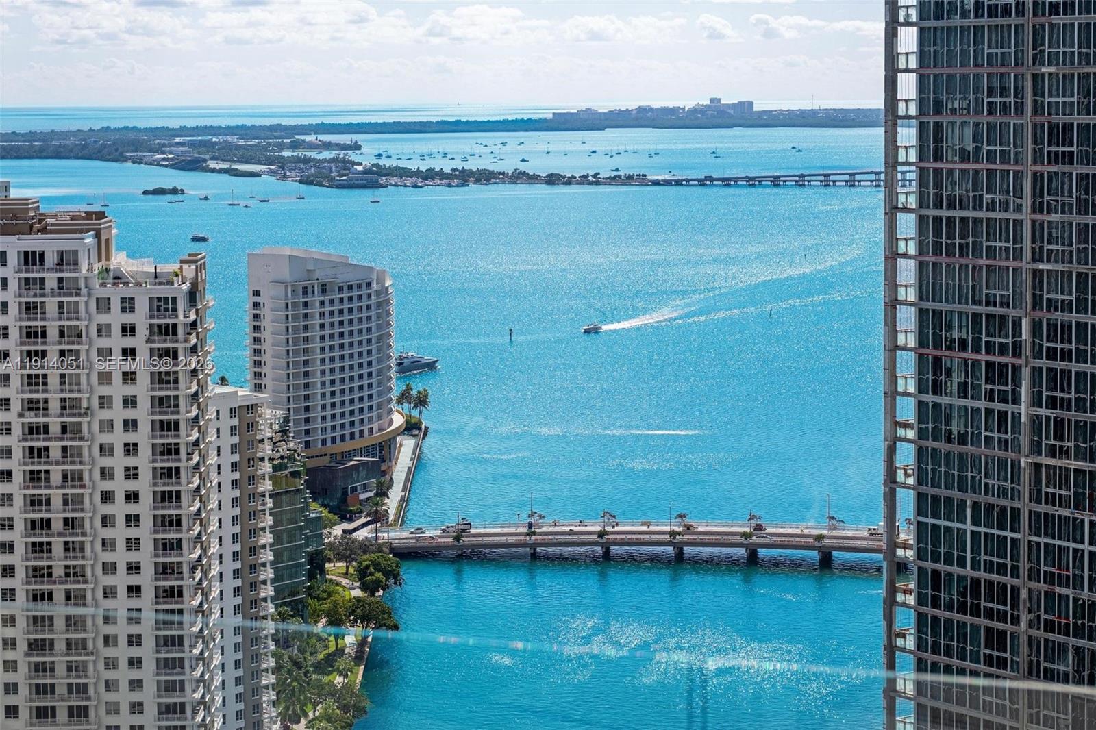 An elevated view of a bay with a bridge, boats, and surrounding high-rise buildings — 300 Biscayne Boulevard Way # 3506W, Miami FL 33131, MIAMI, FL