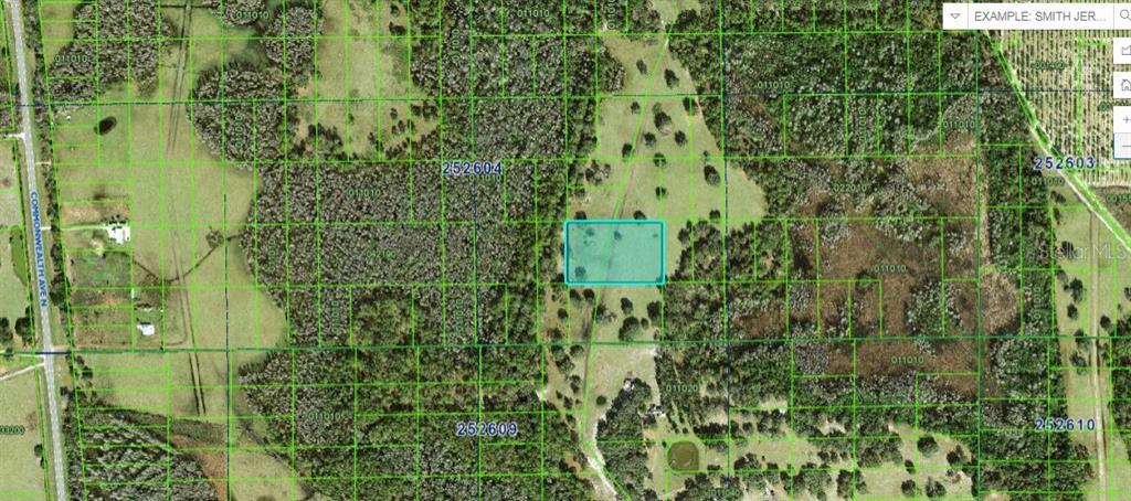 This is a map showing a highlighted rectangular plot of land surrounded by rural terrain — COMMONWEALTH AVENUE N, POLK CITY, FL