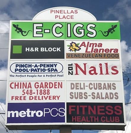 A multi-tenant commercial sign for Pinellas Place lists various businesses including E-Cigs, H&R Block, and others — 6501 102ND AVENUE N, PINELLAS PARK, FL