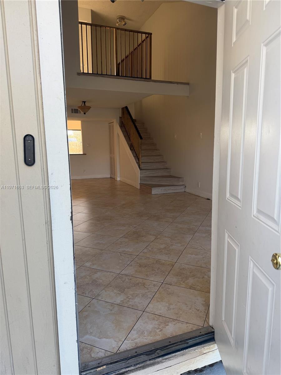 An entryway opens into a living area with tile floors, a staircase, and a loft — 3655 NW 111th Ter, Sunrise FL 33351, SUNRISE, FL
