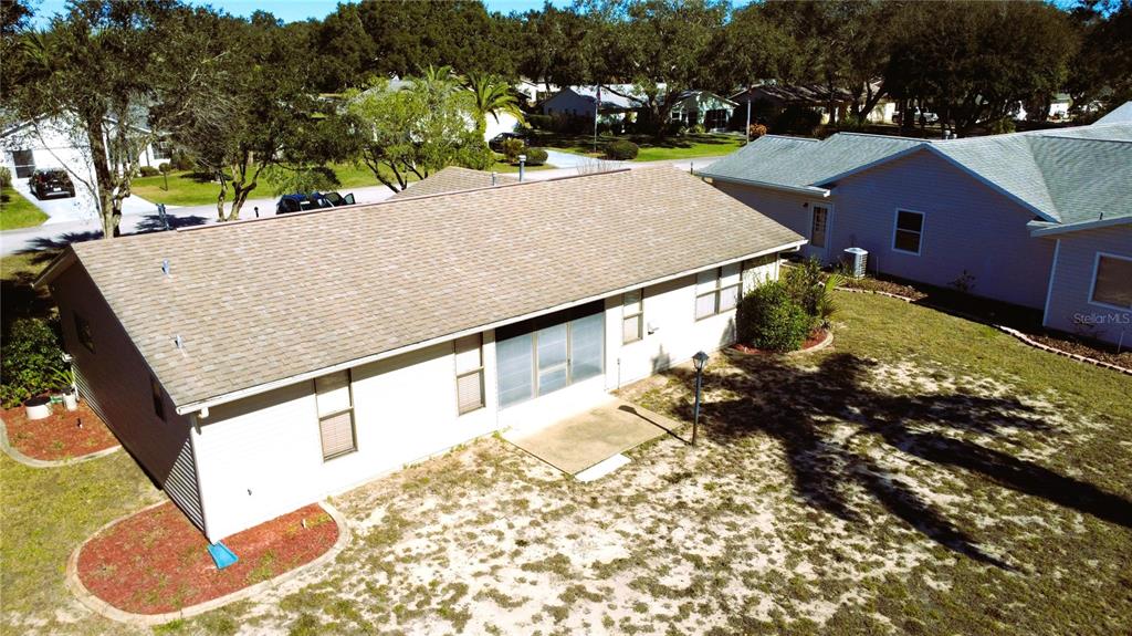 An aerial view of the back of a house with a screened-in porch and yard — 2105 GREENLAW COURT UNIT 2105, LEESBURG, FL