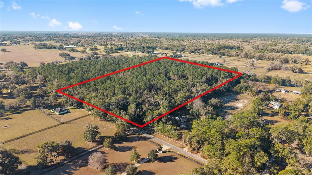 An aerial view shows a rectangular plot of land outlined in red amidst rural fields — TBD SW 125TH AVENUE, OCALA, FL