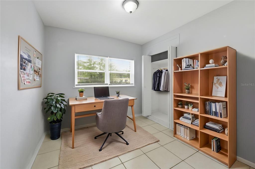 A home office with a desk, chair, bookshelf, and closet on a tiled floor — 116 HOPE CIRCLE, ORLANDO, FL